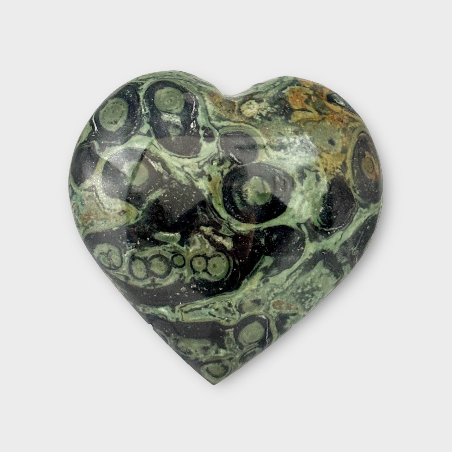 Close-up of a Kambaba Jasper Heart on a plain white background, highlighting its intricate swirls and polished finish.