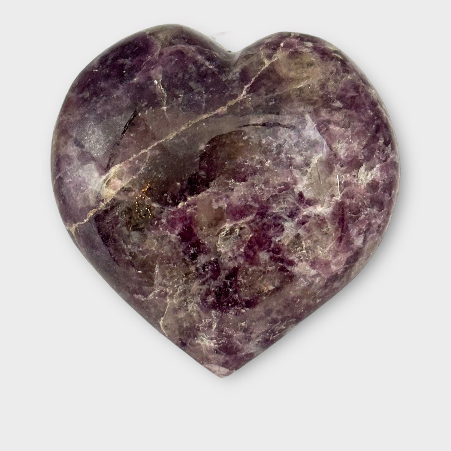 A polished Lepidolite Heart on a plain white background, displaying its gentle lavender tones and subtle stone variations.