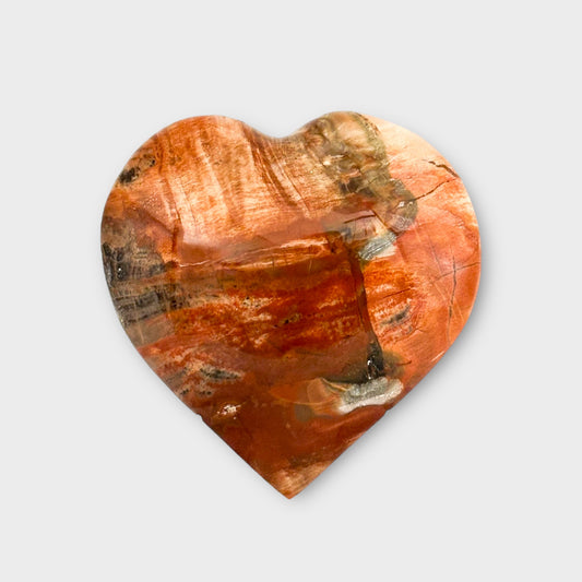 A multi-colored Polychrome Jasper Heart placed on a white background, showcasing its polished finish and rich earthy tones.