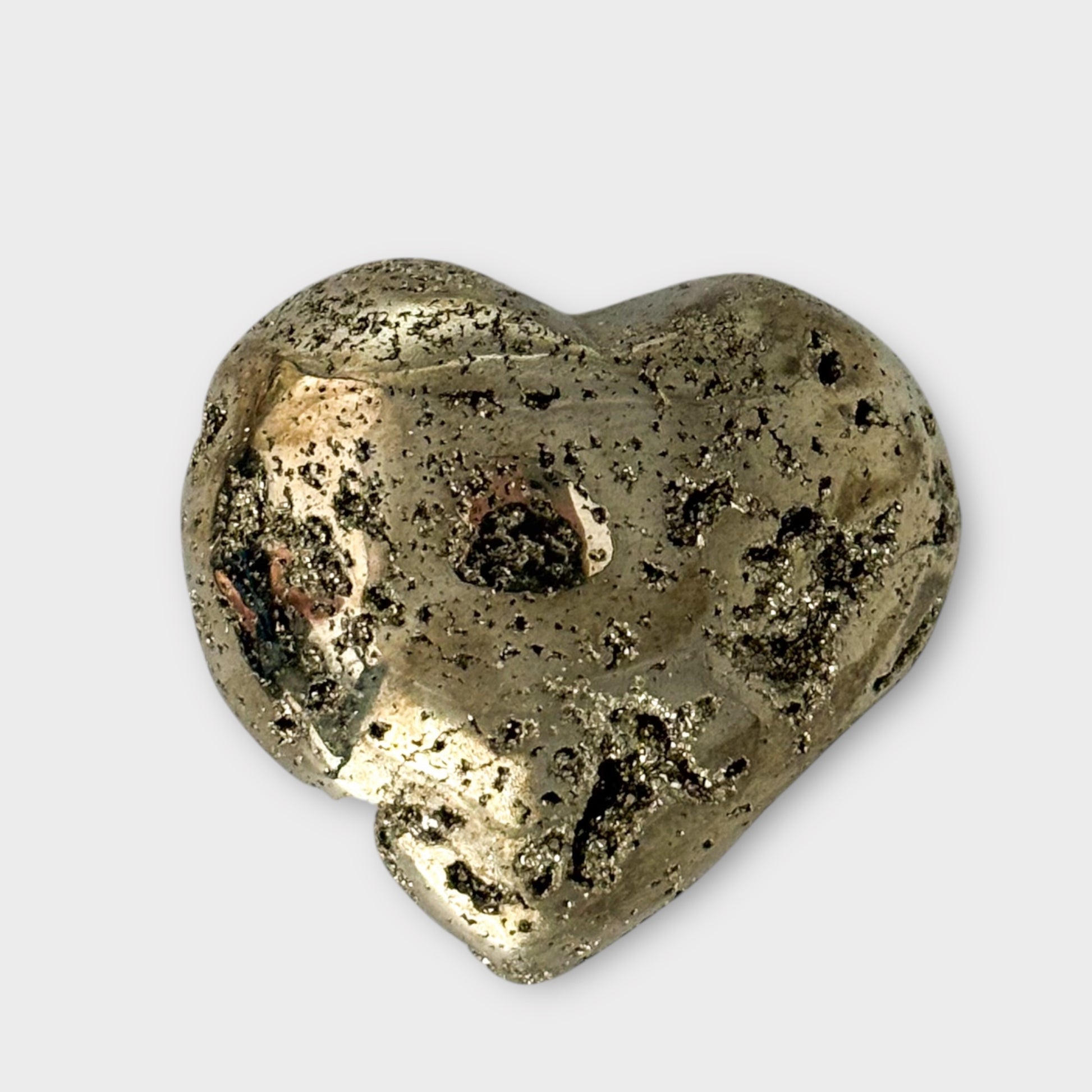 Close-up of a Pyrite Heart on a white background, highlighting its sparkling texture and reflective finish.