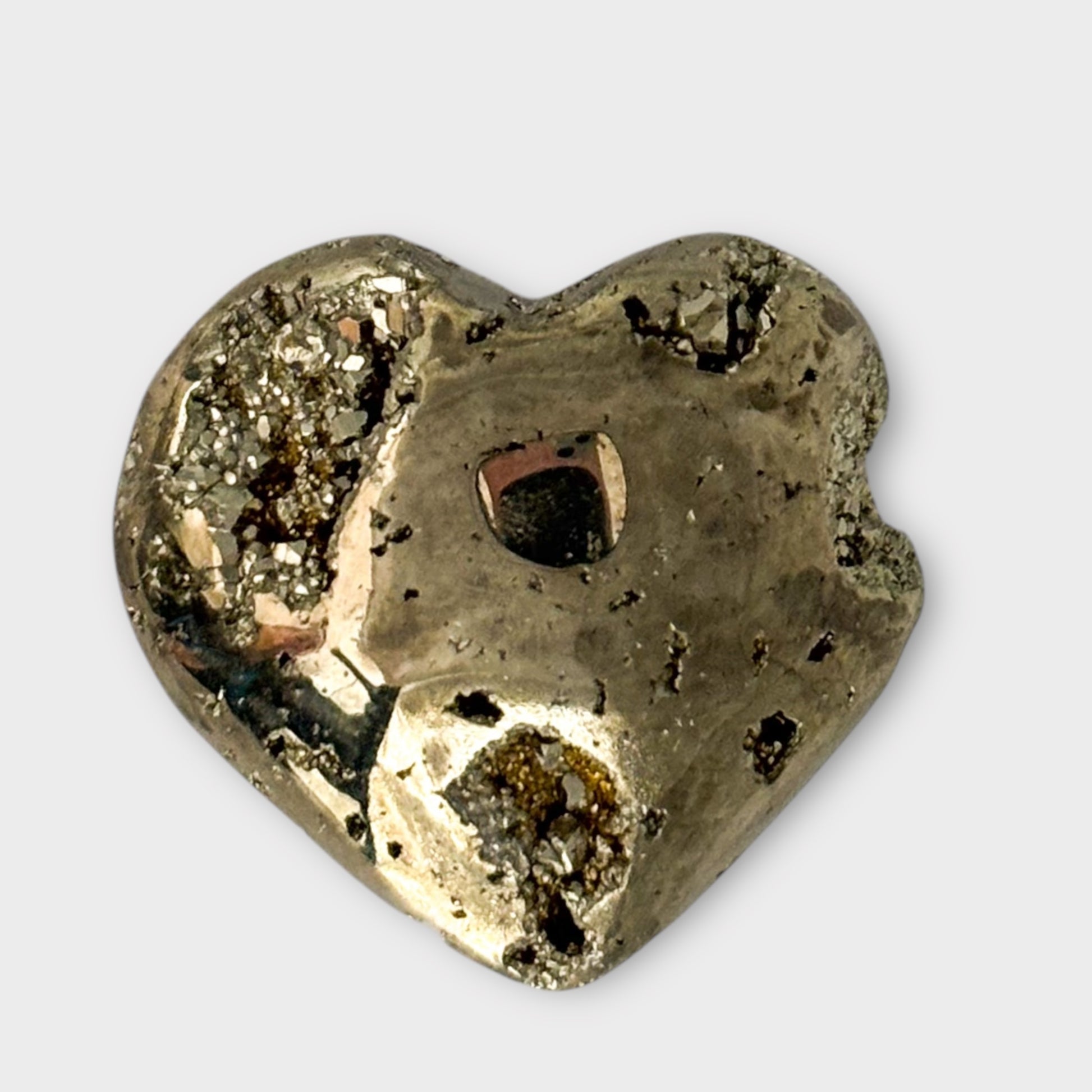 Detailed shot of a Pyrite Heart on a white background, highlighting its intricate golden patterns and polished finish.