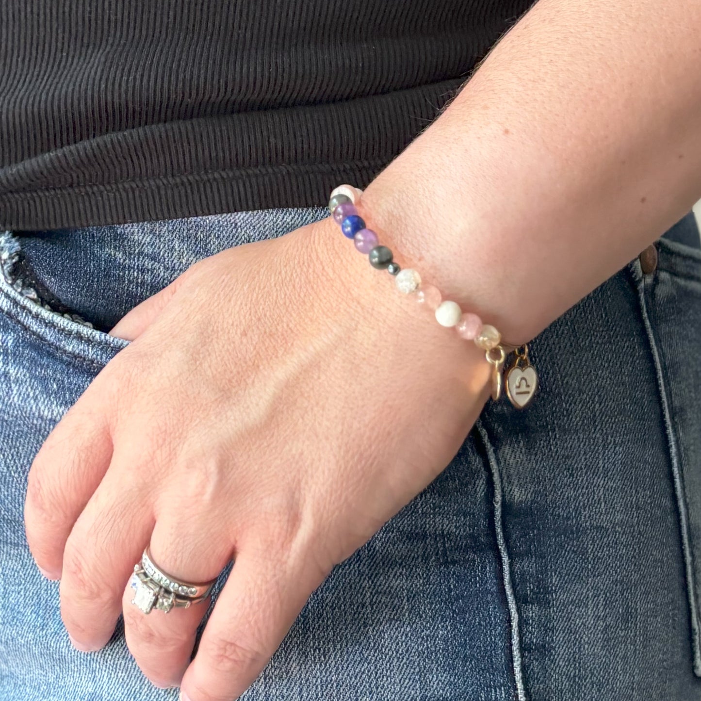 Woman Wearing Zodiac Charm Bracelet